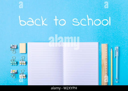 Bright modern minimalistic stationery for school studies on a blue background. With an inscription Back to school. Top view, flat lay Stock Photo