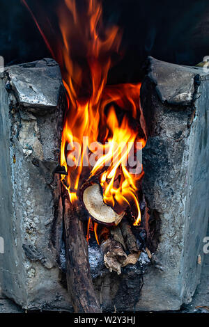 Yellow flame on the log in the oven. Stock Photo