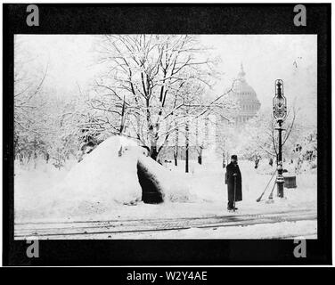 [ Man standing by snow hut, after blizzard of 1888(?), with U.S. Capitol in background, Washington, D.C.] Date Created/Published: [1888?] Stock Photo