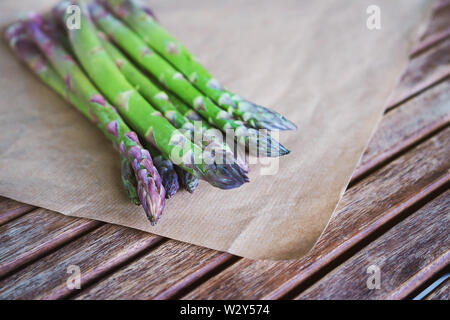 Fresh green asparagus on wooden table background. Stock Photo