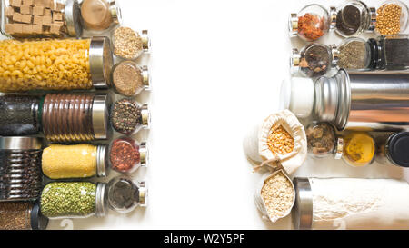 Raw grains, cereals and pasta in glass jars on white table. Healthy cooking, clean eating, zero waste concept. Balanced food. Storage and save. Stock Photo