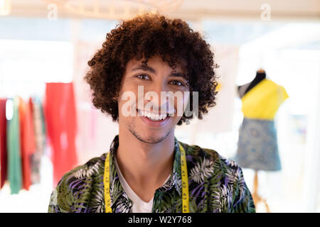 Male fashion designer smiling in design studio Stock Photo