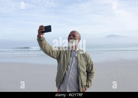 African-American man taking a selfie on the beach Stock Photo