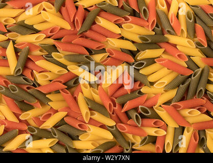 Tri-color penne pasta. Tomato, spinach and wheat pastas. Top view. Stock Photo