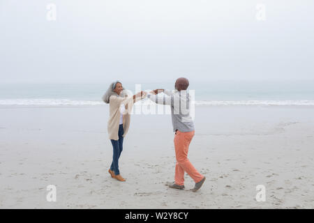 Couple dancing at the beach Stock Photo