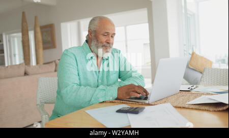 Man using laptop on table Stock Photo