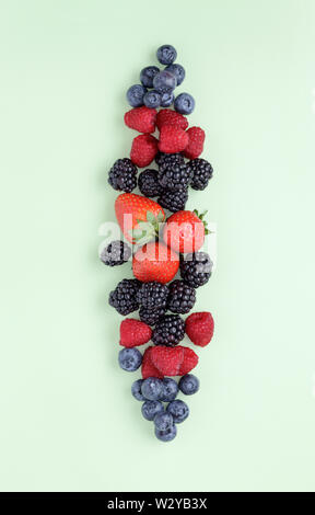 Summer Berries on plain green background Stock Photo