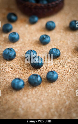 Freshly picked blueberries in woven natural screw pine leaf bowl. Juicy and fresh blueberries with on rustic table. Bilberry on wooden Background. Blu Stock Photo