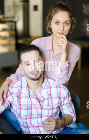 Happy handsome husband sitting with nice wife at home. Concept of spending time together and relationship. Stock Photo