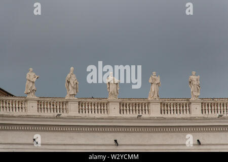 Italy, Vatican city - April 18 2017: the view of colonnade statues with rainy sky on background on April 18 2017, Vatican city state, Italy. Stock Photo