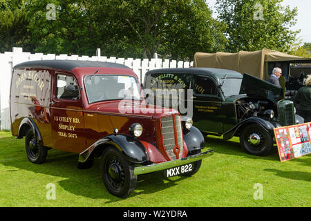 2 restored Jowett Bradford vans (red & dark green) clean shiny exhibits parked on display - Classic Vehicle Show, Burley in Wharfedale, England, UK. Stock Photo