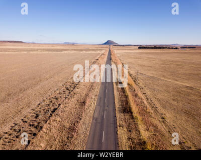 Open road in a grassy landscape Stock Photo