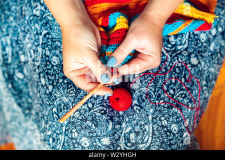 Women's hands crochet. Handmade, needlework and hobby. Close-up, top view. Stock Photo