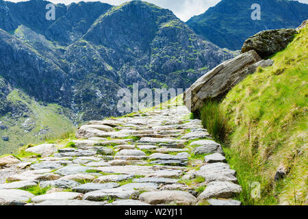 Stone path leading to Snowdon summit, view of the mountains, selective focus. Snowdonia National Park, North Wales Stock Photo