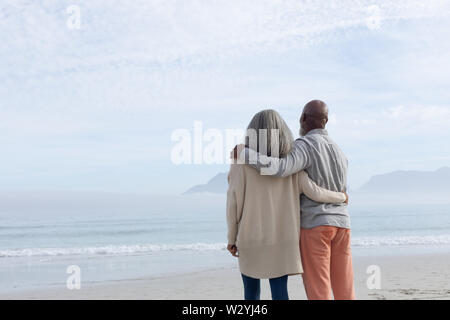 Couple standing on the beach. Stock Photo