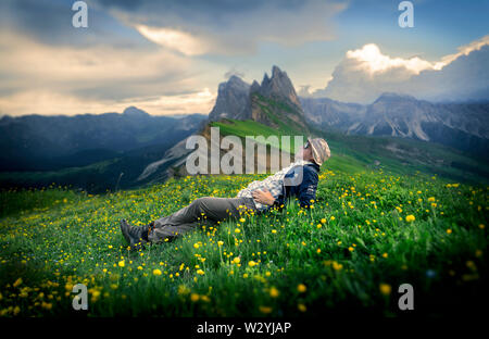 Summer in Dolomite is the best time for trekking and hiking. There are plenty of  grass with beautiful flowers on the hill with spectacular views. Stock Photo