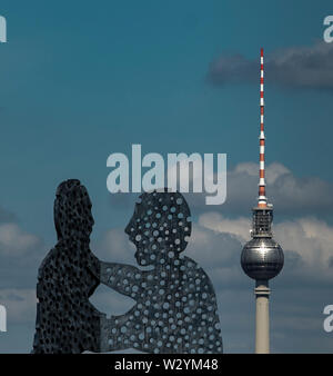 Berlin, Germany. 11th July, 2019. The Molecule Man, a sculpture by the American sculptor Jonathan Borofsky, rises into the sky next to the television tower. Credit: Paul Zinken/dpa/Alamy Live News Stock Photo