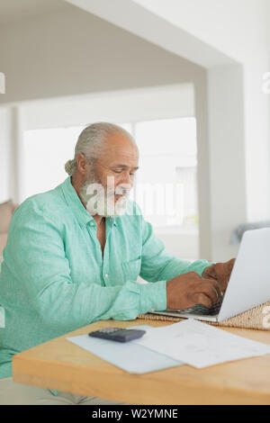 Man using laptop on table Stock Photo