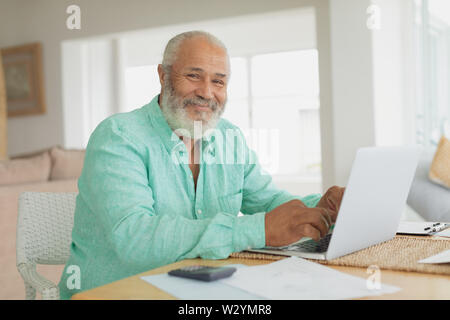 Man using laptop on a table Stock Photo