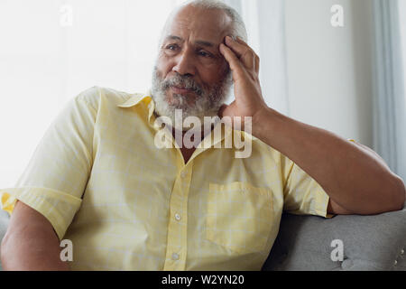 Man sitting on couch Stock Photo