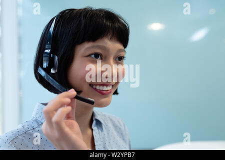 Female customer service executive talking on headset Stock Photo