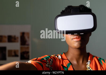 Female graphic designer using virtual reality headset in office Stock Photo