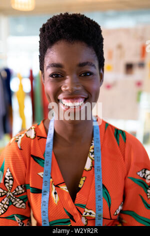 Female fashion designer smiling in design studio Stock Photo
