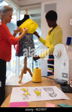 Close-up of sketch paper and thread spool on a table Stock Photo