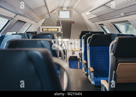 Luxembourg City, Luxembourg - May 18, 2019: Rows of seats inside empty modern line 10 train connecting Luxembourg City with the North of the country, Stock Photo