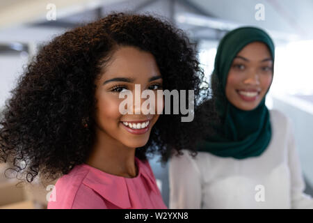 Female executives smiling in office Stock Photo