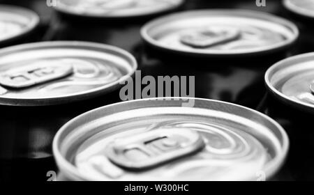 Close up photo of aluminum cans in a raw. Aluminium can background. Can Pattern. Aluminum beverage cans. Drink can. Metal containers for packaging dri Stock Photo