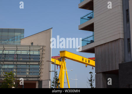 Ireland, North, Belfast, Titanic Quarter, Modern apartment buildings with Harland and Wolff cranes in the background. Stock Photo