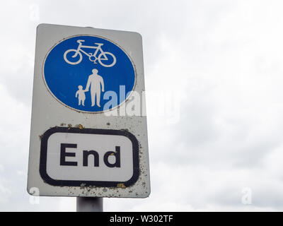 A road sign indicating the end of a shared pedestrian and cycling path. Stock Photo