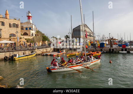 Tel Aviv, Israel - April 13, 2019: Young teenagers on sail boat in the Old Port of Jaffa during a sunny day.