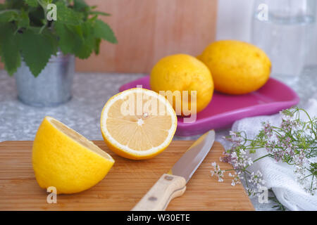 Sliced lemon on a cutting board in a kitchen Stock Photo