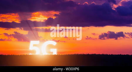 5G rises above the horizon. Network wireless systems and internet of things on surise background. Concept of future technology Stock Photo