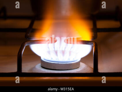 yellow orange gas flame. Burning yellow gas on the stove.   flames of gas burning from a kitchen gas stove Natural resource and Energy saving concept. Stock Photo