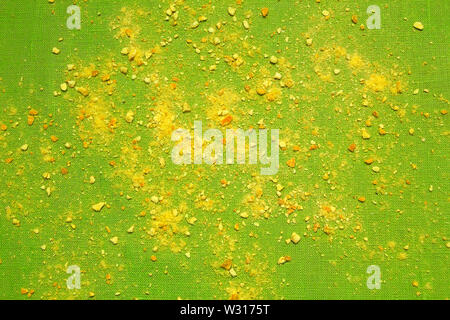 Orange crumb on green background. Abstract. Stock Photo