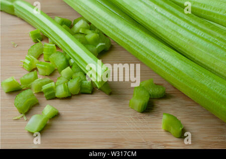 Celery chopped sticks on a wooden cutting board Stock Photo