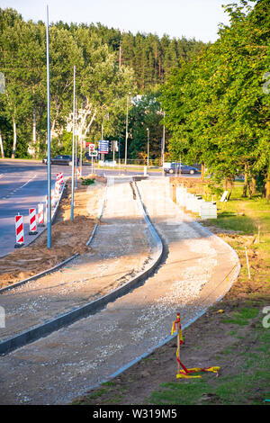 Building a new bike path with sidewalk, bicycle road under construction Stock Photo