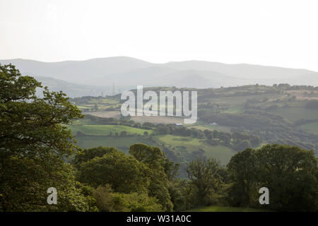 A view along the Vale of Conwy to the mountains of Snowdonia on a summer evening near the village of Eglwysbach Conwy North Wales Stock Photo