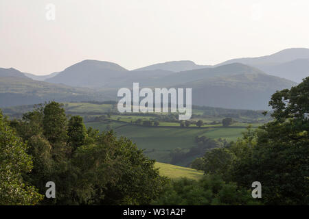 A view along the Vale of Conwy to the mountains of Snowdonia on a summer evening near the village of Eglwysbach Conwy North Wales Stock Photo