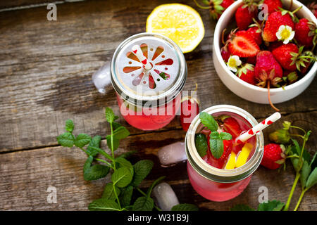 Fresh Strawberry lemonade on rustic wooden table. Stock Photo