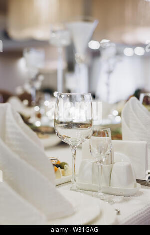 Wine glasses and glasses on the server table.Luxurious elegant dinner at the table in the restaurant. Holiday table decoration Stock Photo