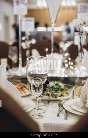 Wine glasses and glasses on the server table.Luxurious elegant dinner at the table in the restaurant. Holiday table decoration Stock Photo