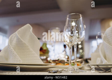 Wine glasses and glasses on the server table.Luxurious elegant dinner at the table in the restaurant. Holiday table decoration Stock Photo