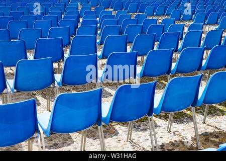 Rows of plastic chairs for spectators in the stands Stock Photo