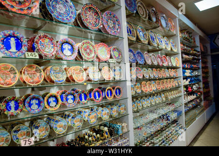 Painted beautiful dishes on the counter. Plates with patterns. Stock Photo