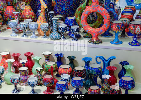 Painted vases and glasses on the counter. Decorated dishes. Stock Photo