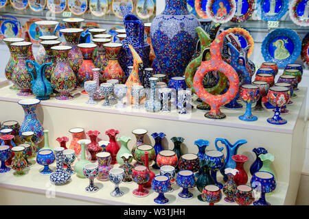 Painted vases and glasses on the counter. Decorated dishes. Stock Photo